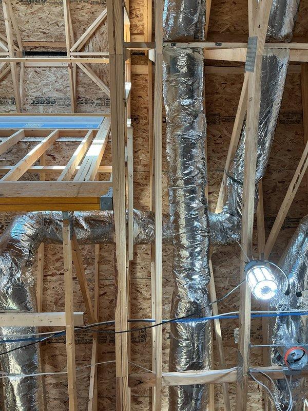 Replaced flexible ductwork with rigid hard pipe on all return air runs in the framed ceiling and wall cavities to improve airflow performance and system durability. Secured and sealed all transitions and connections to boots and collars to ensure proper return air delivery under the new construction warranty.
