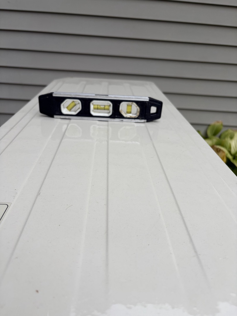 The customer was not home on arrival. I went around to the outdoor unit and leveled the air conditioner. Pictures are attached. All is normal at this time.