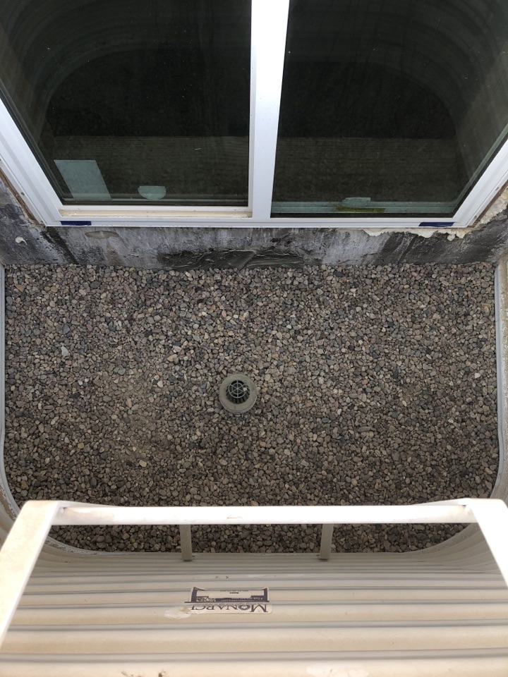 Graveling in inside of new egress window well with window well drain