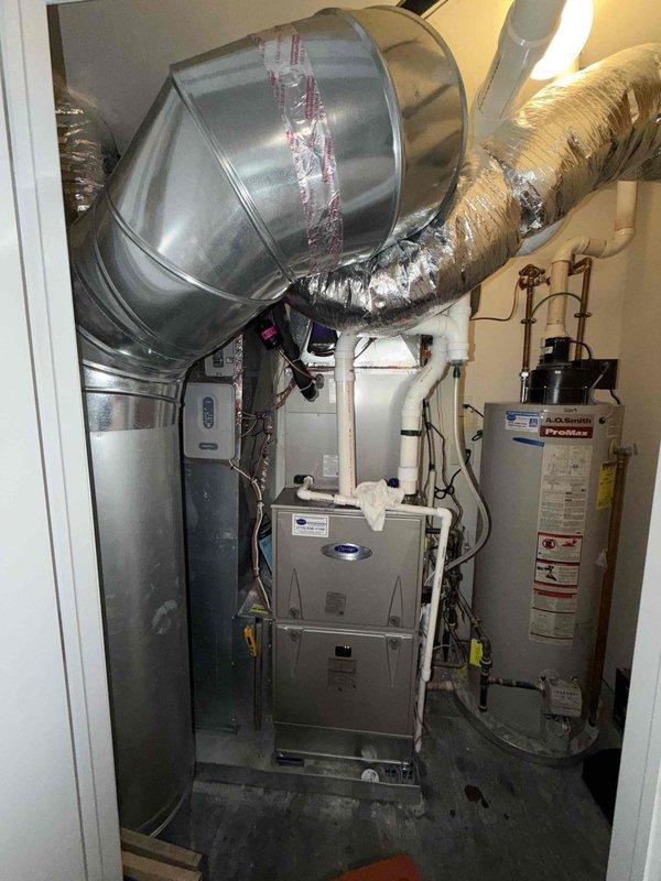 Performed scheduled maintenance on Carrier furnace and water heater per maintenance agreement. Inspected ductwork system, insulation, and connections for proper installation and condition. Temperature check at supply register showed 44.5°F, confirming system is operating within expected parameters.