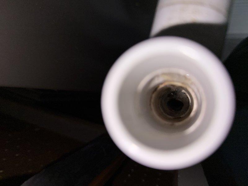Responded to thermostat error code E3. Inspected Aprilaire unit connected to HVAC system and found significant mineral buildup and corrosion in the associated PVC piping. Cleaned sediment accumulation from interior passages to restore proper system function.