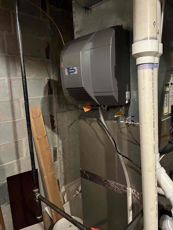 Successfully completed installation of a new Carrier furnace system, including integration of a wall-mounted Carrier humidifier and replacement of the existing thermostat. System was properly connected to the existing PVC venting infrastructure with all necessary drainage components installed according to manufacturer specifications.