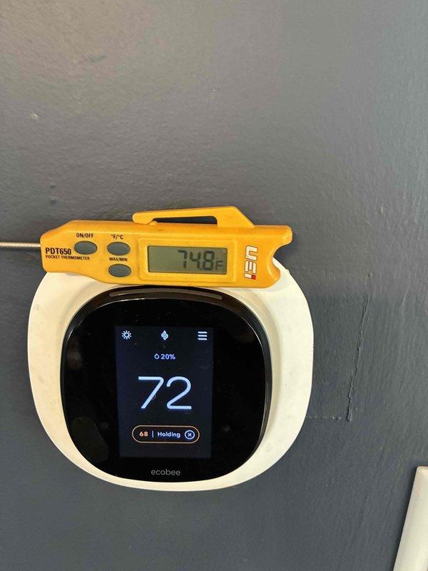 Installed new ecobee smart thermostat as requested by customer. Verified operation and confirmed temperature calibration, noting a 2.8°F differential between thermostat reading (72°F) and calibrated PDT650 digital thermometer (74.8°F). System functioning properly with thermostat maintaining set temperature of 68°F in "Holding" mode.