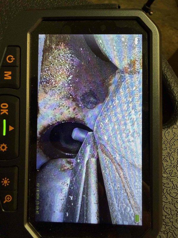 Responded to a no-heat emergency call for an aging furnace (10+ years) exhibiting dangerous conditions. Diagnostic inspection with specialized camera equipment revealed critical safety hazards including carbon monoxide leakage measuring 2000 PPM at exterior exhaust and compromised PVC venting pipe showing heat damage. Additionally identified natural gas leak confirmed by utility company, which had already recommended system shutdown. Observed evidence of moisture damage to blower assembly housing and mounting platform.
