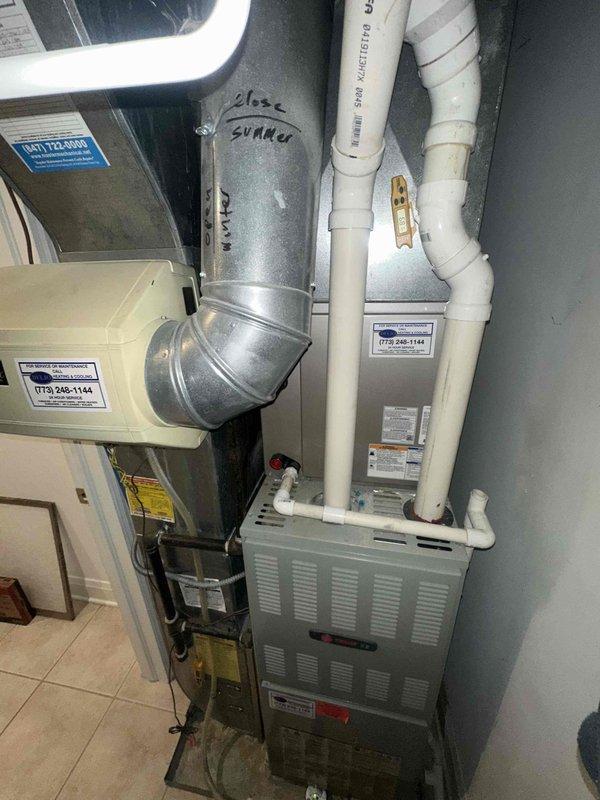Performed routine maintenance on residential HVAC system under agreement COTW. Inspected furnace unit and connected humidifier, documenting condition of blower motor assembly, electrical connections, and ductwork configuration. All components functioning properly with seasonal damper settings verified.