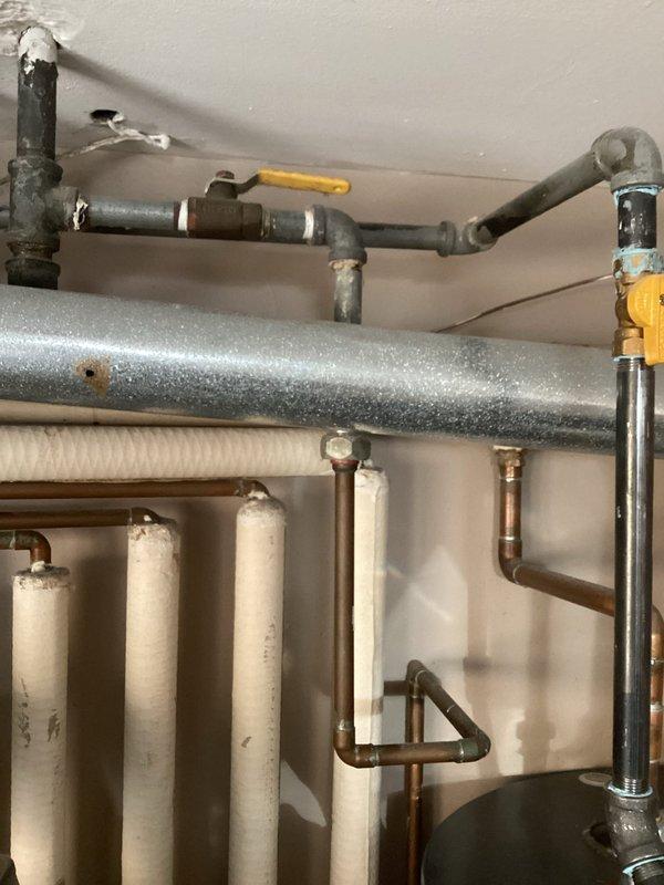 Responded to service call for loud banging in boiler pipes. Diagnosed air entrapment in the hydronic heating system causing water hammer effect. Performed air bleeding procedure on affected piping sections and adjusted system pressure to manufacturer specifications, successfully eliminating the noise issue.