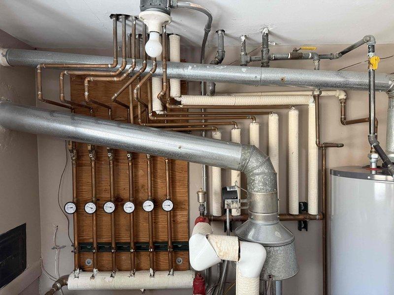 Responded to service call for loud banging in boiler pipes. Diagnosed air entrapment in the hydronic heating system causing water hammer effect. Performed air bleeding procedure on affected piping sections and adjusted system pressure to manufacturer specifications, successfully eliminating the noise issue.