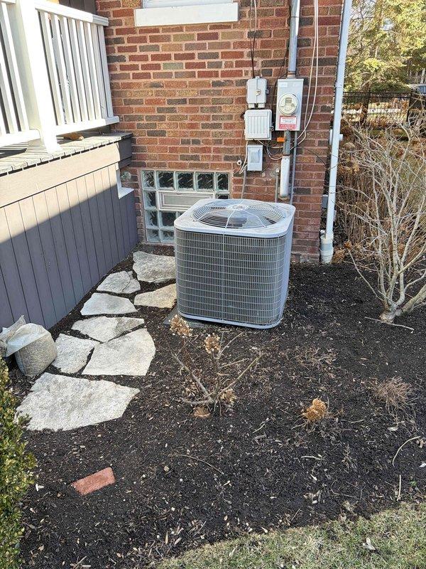 Conducted assessment of 13-year-old HVAC system including Carrier furnace and outdoor AC unit, evaluating repair vs. replacement options. Inspection revealed aging components with purple-marked PVC ventilation connections and documented current filter specifications. System has easy access for replacement with outdoor unit positioned on prepared mulch bed with stone paver surround. Completed evaluation before customer's 1PM departure deadline.