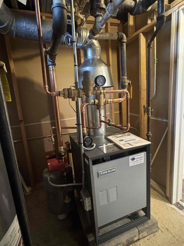 Successfully completed removal of existing boiler system and installed new residential boiler unit in basement utility area. Installation included proper connection of all copper supply and return lines, pressure testing of the system, and verification of all valves and fittings. System was mounted on concrete pad with appropriate clearances and connected to existing hot water heater.