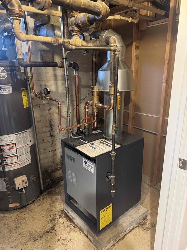Successfully completed removal of existing boiler system and installed new residential boiler unit in basement utility area. Installation included proper connection of all copper supply and return lines, pressure testing of the system, and verification of all valves and fittings. System was mounted on concrete pad with appropriate clearances and connected to existing hot water heater.