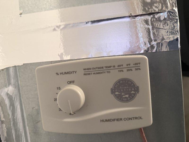 Responded to no-heat call for system less than 10 years old. Discovered humidifier leaking which had tripped the safety device and shut down the furnace. Inspected and replaced the clogged humidifier filter pad which showed significant mineral buildup, and adjusted the humidistat from near-off position to appropriate setting for current outside temperature.