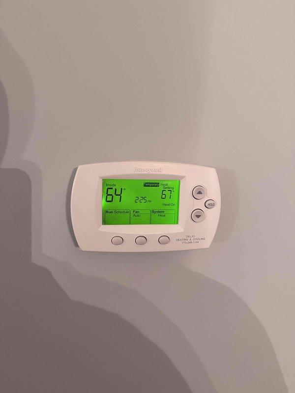 Responded to service call for boiler displaying error code E-012 and not turning on. Diagnosed thermostat settings and verified proper heat call signal at 67°F setpoint with current room temperature at 64°F. Inspected boiler control panel and reset system using red reset button, which cleared the error code and restored normal operation.