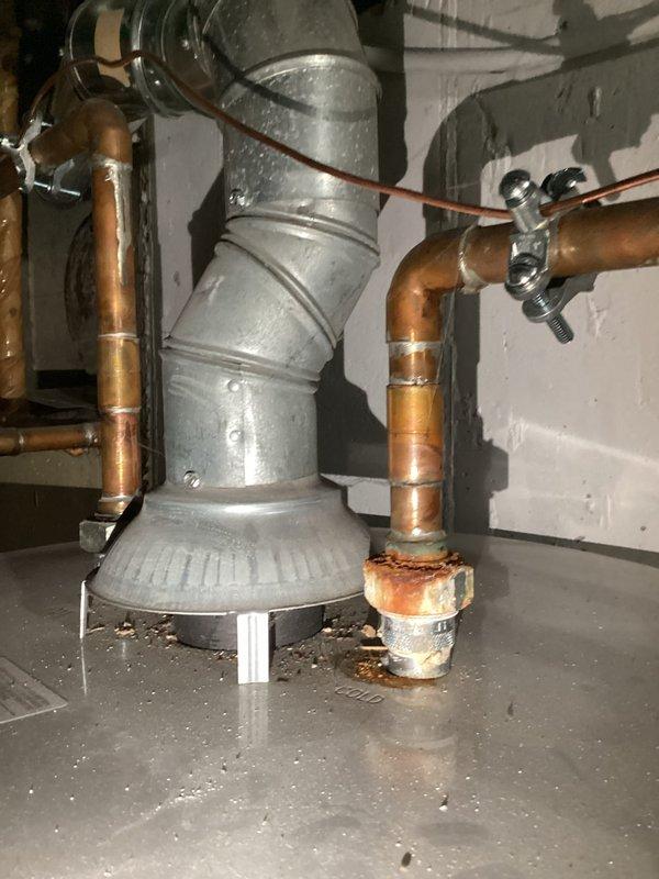 Responded to a no-heat emergency call for a water heater system less than one year old. Upon inspection, identified oxidation and corrosion at copper pipe connections near the galvanized metal drain pipe. Cleaned affected fittings, verified proper venting of the automatic storage water heater, and restored system functionality. Customer confirmed heat was working properly before service completion.