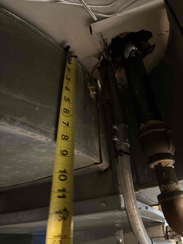 Performed comprehensive evaluation of 2012 furnace exhibiting inducer motor failure. Inspected ductwork connections and measured clearances, noting significant metal deterioration and possible corrosion at junction points. Recommended full system replacement due to age of existing equipment (2001 AC unit) and safety concerns with current installation.