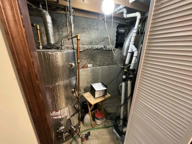Conducted full system estimate for replacement of aging 17-year-old HVAC equipment with new 2-stage furnace and air conditioner. Inspection revealed existing installation in basement utility area with complex PVC drainage/ventilation network and current furnace showing signs of age-related wear. Photographs documented current system configuration and installation constraints for proper sizing and placement of recommended replacement equipment.