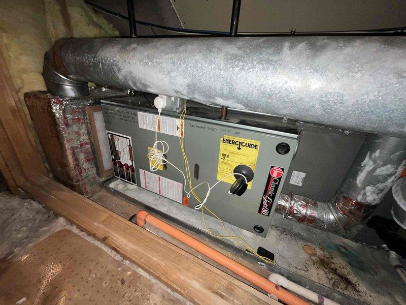 Performed comprehensive evaluation of 2009 attic furnace system to assess repair versus replacement options. Inspection revealed aging unit with visible wear to ductwork connections and insulation deterioration. Documented condition of furnace, associated ductwork, gas line connections, and existing installation framework to provide accurate replacement recommendations.