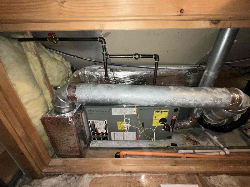 Performed comprehensive evaluation of 2009 attic furnace system to assess repair versus replacement options. Inspection revealed aging unit with visible wear to ductwork connections and insulation deterioration. Documented condition of furnace, associated ductwork, gas line connections, and existing installation framework to provide accurate replacement recommendations.