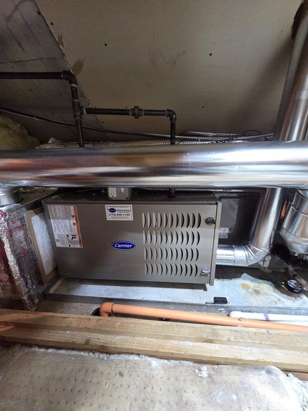 Successfully installed new Carrier furnace unit with integrated humidifier in utility area. Completed all necessary ductwork connections, including proper installation of metal piping and copper line connections. System was tested and is functioning according to manufacturer specifications.