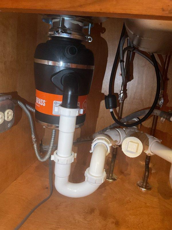 Completed comprehensive plumbing system assessment and sold repair services for multiple issues. Identified and recommended replacement for thermostatic shower cartridge, toilet rebuild, corroded p-trap in basement laundry area, and provided replacement options for three angle stops, kitchen faucet, and garbage disposal unit. Documented existing conditions with detailed photos for service record.
