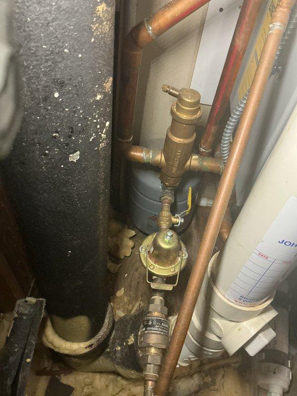 Performed routine maintenance on Triangle Tube Prestige boiler and explained to customer about ceased operations with Triangle Tube manufacturer. Inspected system parameters including boiler supply temperature (96°F), return temperature (88°F), flue temperature (104°F), and outdoor temperature (56°F). Examined plumbing components including brass regulator valve and checked for signs of previous leakage indicated by mineral deposits.