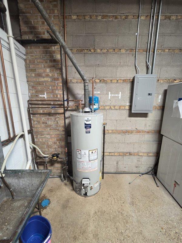Successfully removed existing 40-gallon water heater and installed new 50-gallon natural draft unit in utility area. Completed all necessary copper pipe connections, installed expansion tank, and ensured proper venting. System tested and functioning correctly with no leaks observed.