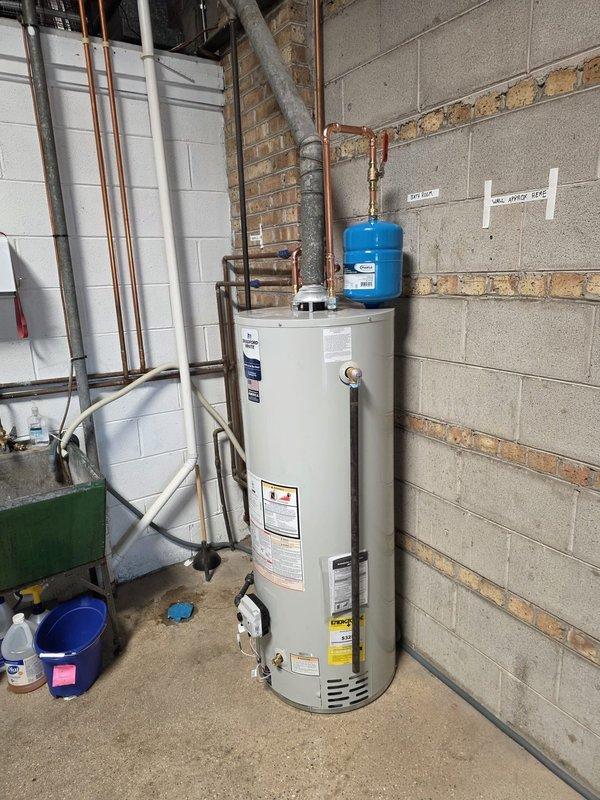 Successfully removed existing 40-gallon water heater and installed new 50-gallon natural draft unit in utility area. Completed all necessary copper pipe connections, installed expansion tank, and ensured proper venting. System tested and functioning correctly with no leaks observed.