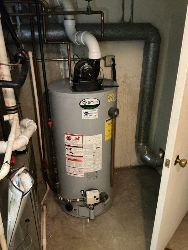Performed diagnostic inspection on 5-year-old A.O. Smith tanked water heater system located in utility area. Conducted visual assessment of all connections including copper supply lines, PVC drainage, and metal vent piping. Verified proper installation and function of temperature/pressure relief valve and checked shower fixtures for consistent hot water delivery. System is operating within normal parameters with no leaks detected at plumbing connections or tank seams.
