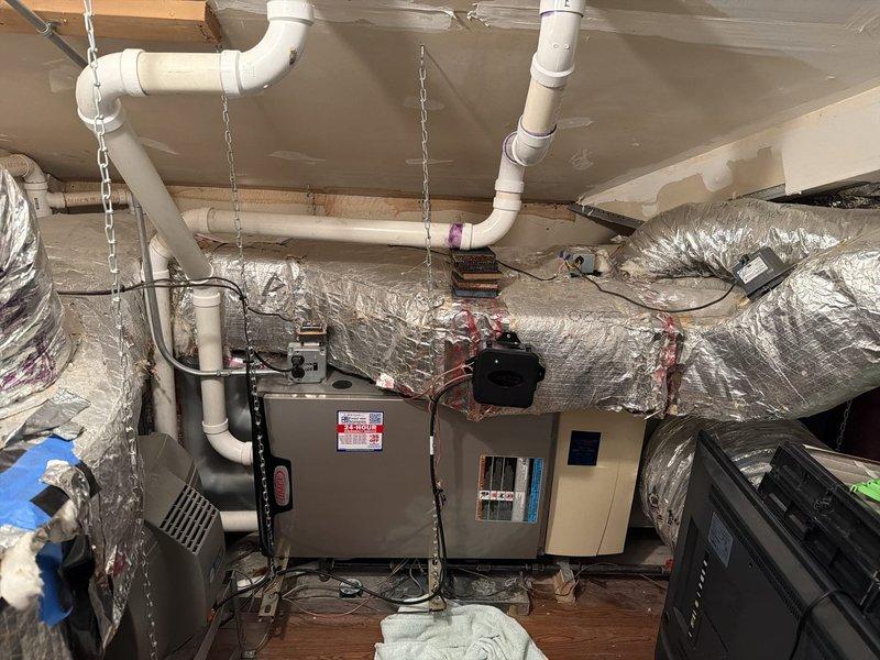 Responded to service call regarding previously repaired PVC condensate drain line that had developed a leak. Applied new PVC primer and cement to the compromised elbow joint connection, ensuring proper sealing. Inspected the entire condensate drain system and verified proper drainage function after repair.