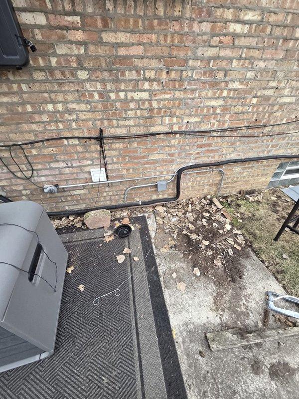 Successfully completed installation of new condenser unit, evaporator coil, and humidifier system at residential property. System was properly mounted on concrete pad against exterior brick wall with all utility connections secured. Interior components were installed with proper access panel configuration for future maintenance.