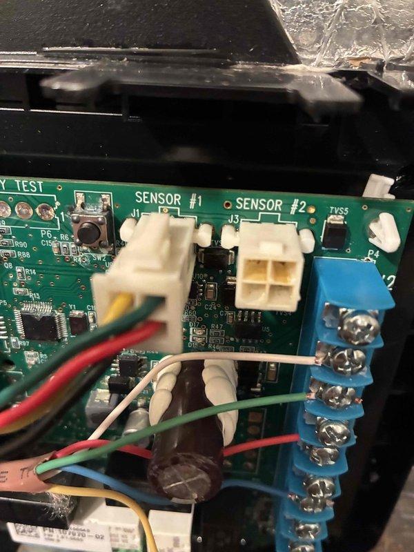 Responded to emergency heating service call for 2-year-old HVAC system experiencing issues on second and third floors. Performed diagnostic inspection of control board, identifying faulty connections at the blue terminal block where sensor wiring had become loose. Reconnected and secured all wiring to appropriate terminals, tested system functionality through complete heating cycle, and verified proper operation on all affected floors.