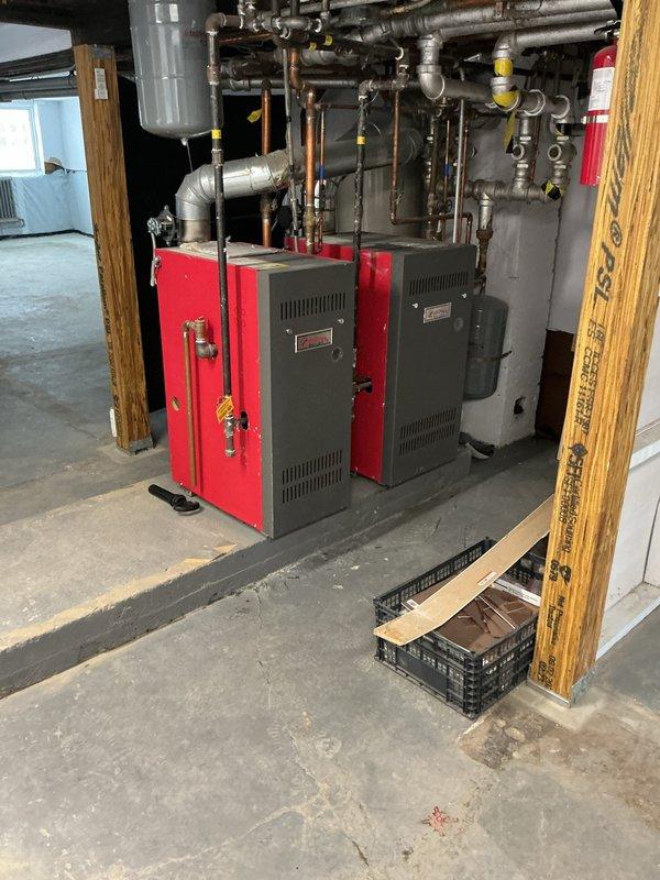 Conducted diagnostic inspection on leaking boiler system, identifying excessive dripping from water pressure release valve causing water accumulation in basement. Examined dual boiler units (circa 2019), associated plumbing network, and thermostat system functioning, documenting conditions with photographic evidence prior to scheduled bank appraisal.