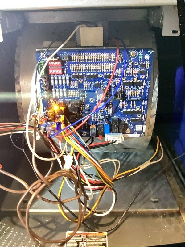 # Service Report: No Heat Call - Carrier Furnace

Responded to a no-heat service call on a Carrier furnace system over 10 years old. Customer requested a second opinion following a previous diagnosis from another contractor.

Upon arrival, performed complete system diagnostic to identify cause of no-heat condition. Conducted visual inspection of all major components including heat exchanger, blower assembly, and control board. Accessed blower compartment and inspected squirrel cage blower wheel, noting significant dust and debris accumulation on blades and assembly. Heavy contamination on blower wheel reduces airflow efficiency and can trigger safety limit switches, preventing proper heating operation.

Examined electronic control board and associated wiring connections. Control board showed normal wear consistent with age of unit. Inspected all wire terminations including thermostat connections (white, red, blue, yellow, brown) for proper seating and continuity. Verified control board