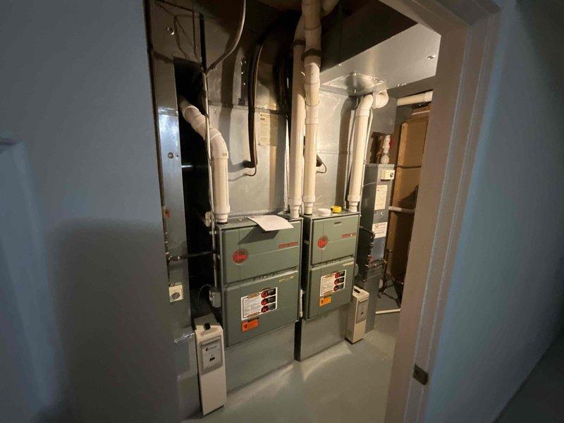 Provided comprehensive estimate for complete replacement of two HVAC systems in residential property built in 2001. Assessed existing dual furnace and air conditioning configuration currently installed in basement mechanical room, along with outdoor condenser units positioned on concrete pads in backyard landscaping area. Customer expressed interest in available spring rebates and federal tax credit opportunities for new high-efficiency equipment installation.