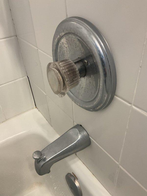 Completed comprehensive plumbing inspection following water heater installation. Identified and documented leaking basement utility sink with corroded supply line fittings and floor staining indicating ongoing water damage. Assessed upstairs bathroom fixtures, noting severely corroded chrome shower valve assembly, escutcheon plate, and tub spout with significant mineral deposits and water staining requiring drain clearing service.
