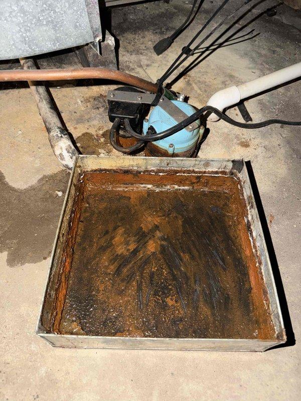 Completed comprehensive maintenance agreement check on one furnace and one air conditioning system. Performed refrigerant pressure testing on the outdoor AC unit using manifold gauges, verifying system charge levels and operational parameters. Inspected condensate drainage system and noted significant rust and corrosion in the floor-mounted drain pan with evidence of standing water, indicating potential need for future pan replacement to prevent water damage. All equipment operational at time of service completion.
