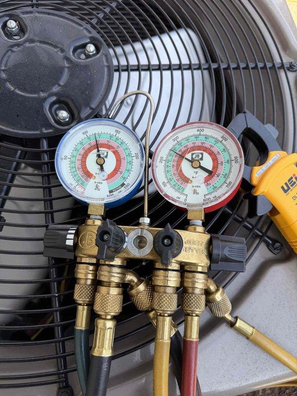 Completed comprehensive maintenance agreement check on one furnace and one air conditioning system. Performed refrigerant pressure testing on the outdoor AC unit using manifold gauges, verifying system charge levels and operational parameters. Inspected condensate drainage system and noted significant rust and corrosion in the floor-mounted drain pan with evidence of standing water, indicating potential need for future pan replacement to prevent water damage. All equipment operational at time of service completion.