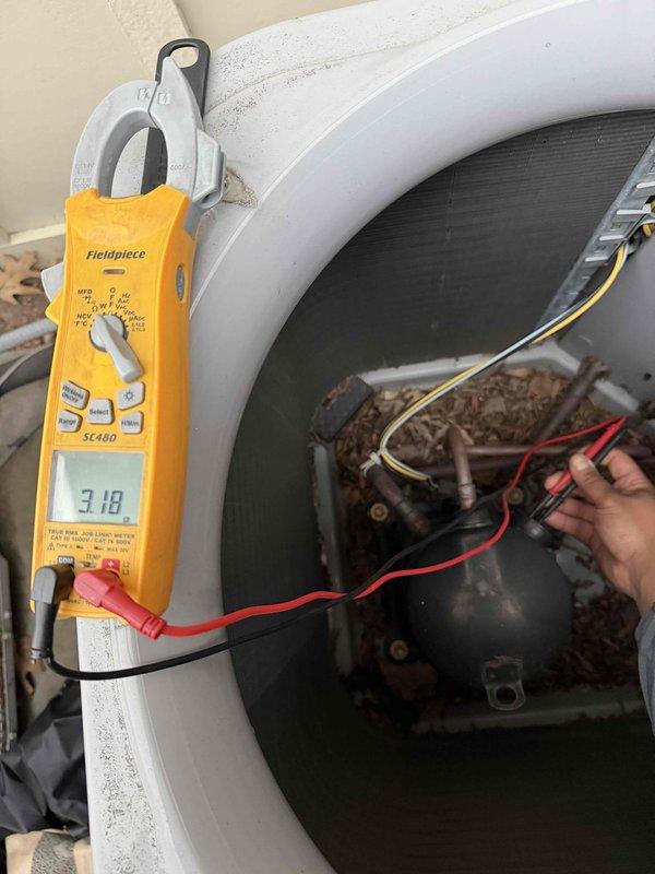 Responded to no cooling complaint on residential air conditioning system. Upon arrival, performed diagnostic testing using multimeter to check electrical components and compressor operation. Measured voltage at compressor terminals, reading 3.18 volts which indicated potential electrical supply issue or failed component. Inspected blower assembly and internal components, noting accumulated dust and debris on surfaces. Conducted thorough examination of motor, capacitor connections, and wiring harness. System blowing warm air due to compressor not engaging properly. Recommended further evaluation of start components and capacitor to restore cooling operation.
