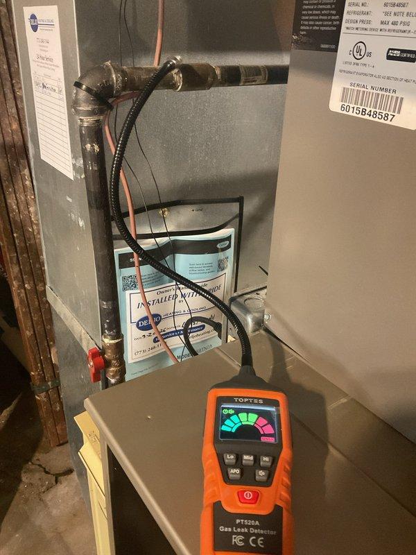 Responded to reported faint gas smell from furnace. Performed comprehensive gas leak detection using calibrated electronic detector throughout unit and associated gas piping connections. Inspected all gas line fittings, including compression coupling on supply line and connections at furnace manifold. No active gas leaks detected during testing. Verified proper operation of all safety controls and documented findings with photographic evidence. Unit operating within normal parameters at time of inspection.