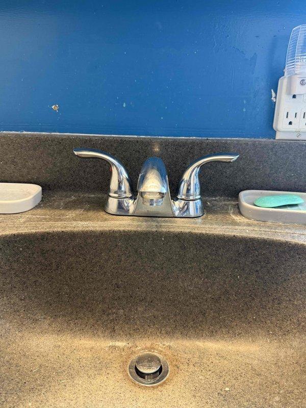 Completed plumbing repair work for basement sink and second-floor bathroom as previously estimated. Installed new chrome two-handle faucet with curved spout design on second-floor bathroom vanity, ensuring proper mounting and secure water supply connections. Tested both hot and cold water lines for leaks, verified proper drainage function, and confirmed all fixtures are operating correctly with no drips or water pressure issues.