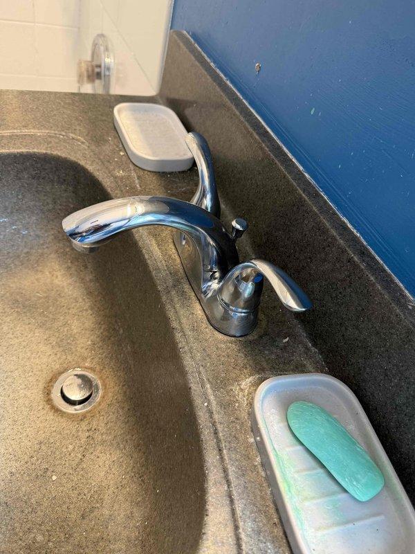 Completed plumbing repair work for basement sink and second-floor bathroom as previously estimated. Installed new chrome two-handle faucet with curved spout design on second-floor bathroom vanity, ensuring proper mounting and secure water supply connections. Tested both hot and cold water lines for leaks, verified proper drainage function, and confirmed all fixtures are operating correctly with no drips or water pressure issues.