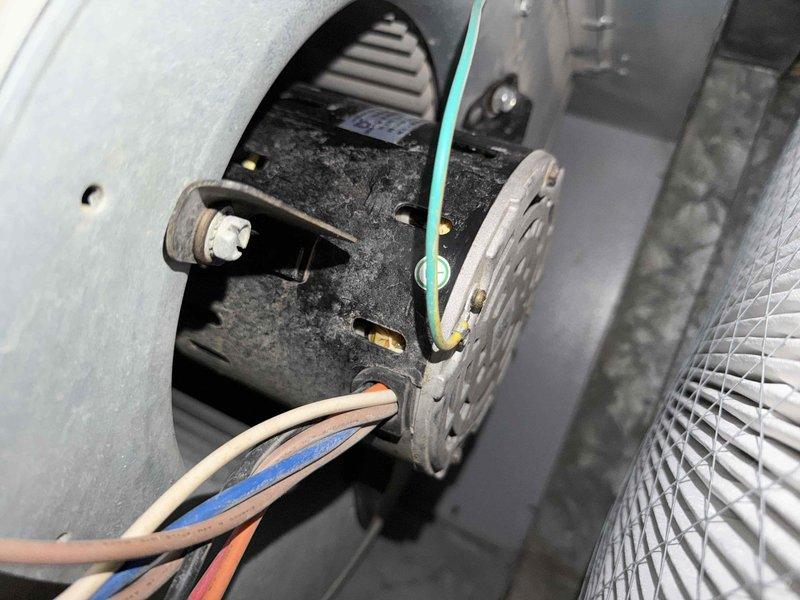 Completed air conditioning maintenance agreement inspection. Verified thermostat operation showing 70°F ambient temperature with cooling setpoint at 61°F. Accessed and inspected blower assembly, documenting significant dust and debris accumulation on blower wheel, housing interior, and base platform requiring attention for optimal system performance.