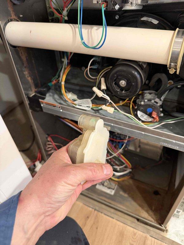 Performed comprehensive furnace inspection and cleaning for new homeowner. Accessed interior components, inspected blower wheel assembly which showed moderate dust accumulation on blades, examined drainage system and PVC condensate lines, and verified all electrical connections and safety controls were functioning properly. Discussed preventive maintenance membership program options with customer to ensure ongoing system reliability.