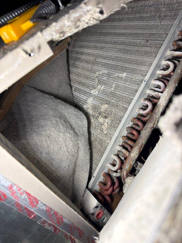 # HVAC Maintenance Service Completed

Performed comprehensive AC maintenance on an attic-mounted air handler unit requiring ladder access. Conducted thorough inspection of the evaporator coil assembly, which displayed moderate dust and debris accumulation on aluminum fins consistent with normal operational wear. Examined copper refrigerant lines showing age-related oxidation and surface discoloration. Inspected blower wheel assembly, confirming clean operational condition with no debris buildup on blades or housing. Verified proper mounting and structural integrity of all components within the air handler cabinet. System operational and functioning within normal parameters upon completion of maintenance inspection.