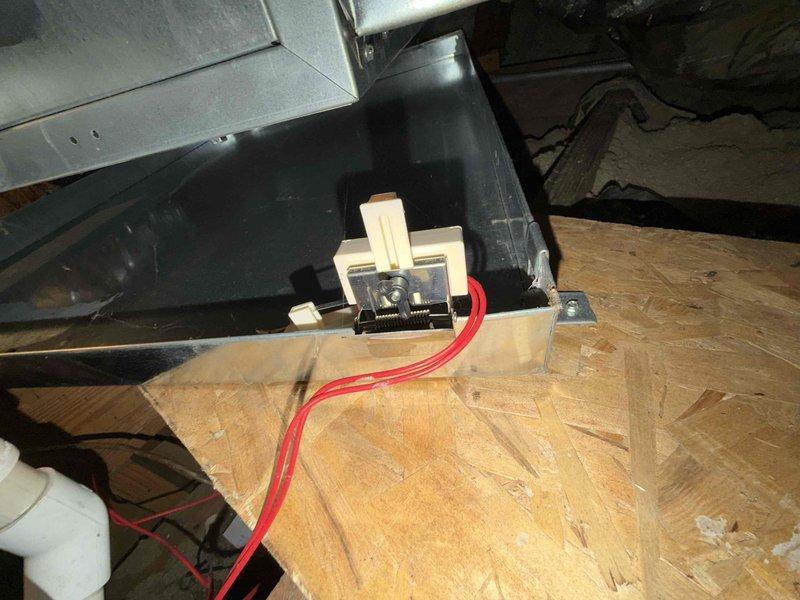 Completed comprehensive cooling check on air conditioning system and air handler general service in attic installation. Performed thorough inspection of suspended air handler unit, verified proper chain mounting and structural support from ceiling joists, and documented all manufacturer labels and AHRI certification stickers. Inspected electrical components including relay switch with red wiring, confirmed proper connections and functionality. Verified PVC condensate drain line installation and routing. System found operating within normal parameters with all safety devices and controls functioning properly.