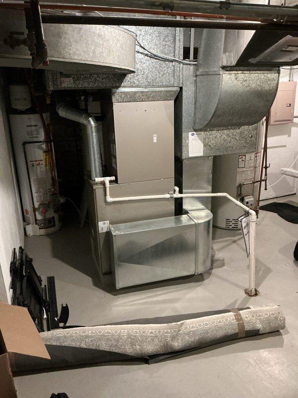 Responded to no cooling complaint on 10+ year old system displaying low pressure lockout and frozen coil error codes. Upon inspection, measured supply air temperature at 53.6°F, confirming inadequate cooling performance and indicating restricted airflow or refrigerant issue causing coil to freeze. Documented system conditions with photos showing evaporator coil area and temperature readings for diagnostic purposes.