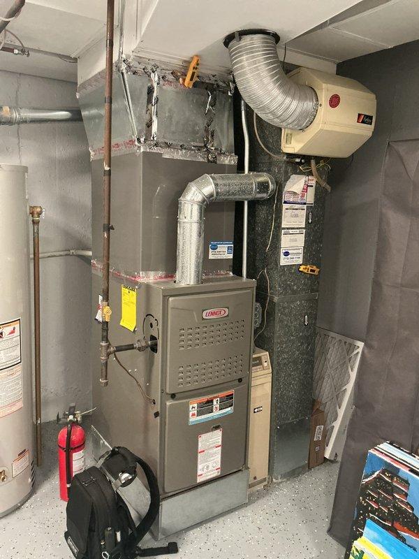 Completed comprehensive cooling check, air conditioning general service, and maintenance agreement inspection on Lennox HVAC system. Performed thorough system evaluation including visual inspection of furnace unit, ductwork connections, and associated components in mechanical room. Inspected and replaced air filters, noting significant dust accumulation on existing filter media. Verified proper operation of heating and cooling equipment, checked refrigerant levels, tested airflow, and ensured all safety controls functioning correctly. Documented equipment condition with photographs showing furnace, water heater, and utility room configuration. All system components operating within normal parameters upon completion of scheduled maintenance service.