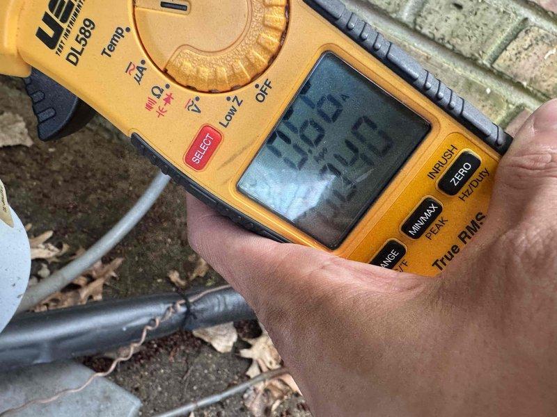 Completed comprehensive air conditioning maintenance and system inspection as part of customer agreement. Verified electrical readings using digital multimeter, confirming proper voltage and amperage levels at outdoor unit. Inspected condensate drain system and positioned drain pan beneath water heater connections to protect against potential leaks.
