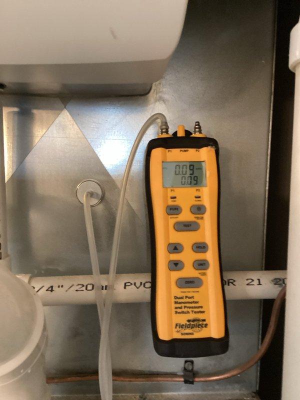 Responded to no cooling complaint on 10+ year old American Standard system with R-410A refrigerant. Performed diagnostic evaluation and discovered upstairs condenser coil showing signs of potential refrigerant leak. Utilized Fieldpiece digital manifold gauges to measure system pressures and confirm low refrigerant charge. Documented equipment model TE31630D175B1605AP and inspected mechanical room installation including furnace, air handler, and associated refrigerant lines. Customer advised of findings and recommended further leak detection testing to determine exact location and extent of coil damage before proceeding with refrigerant recharge.