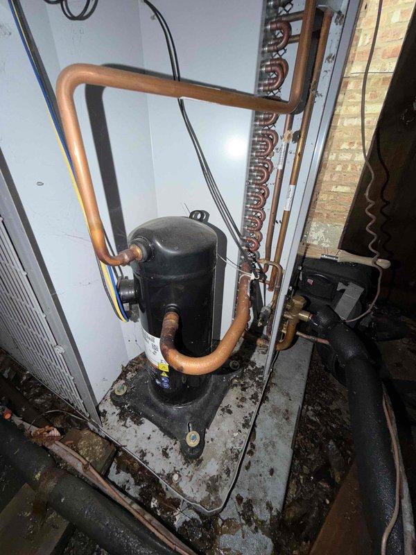 Completed preventive maintenance agreement inspection on residential HVAC system including indoor furnace unit and outdoor condenser compressor. Performed visual assessment of equipment condition, refrigerant line connections, electrical components, and mounting platforms. Documented current system status with photos showing operational equipment, copper line configurations, and installation environment for maintenance records.