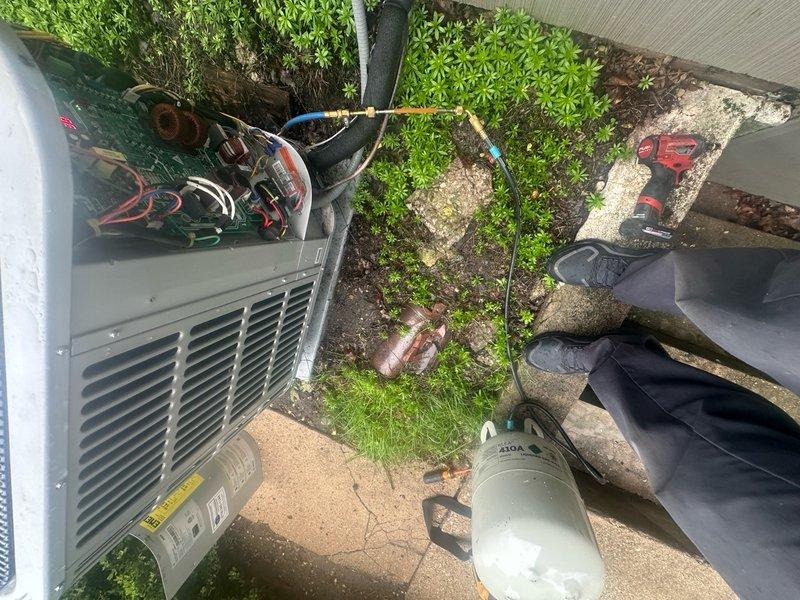Returned to property to complete refrigerant leak search using electronic leak detector on split system air conditioning unit. Accessed outdoor condenser unit and indoor evaporator coil compartment to systematically test all refrigerant lines, fittings, and brazed connections. Utilized recovery equipment and manifold gauges to isolate system components during leak detection process. Inspected all accessible copper refrigerant lines, service valves, and brass fittings for potential leak points while monitoring detector response.